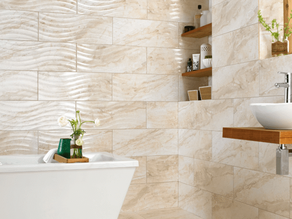 spa bathroom with cream textured tiles and a freestanding bath