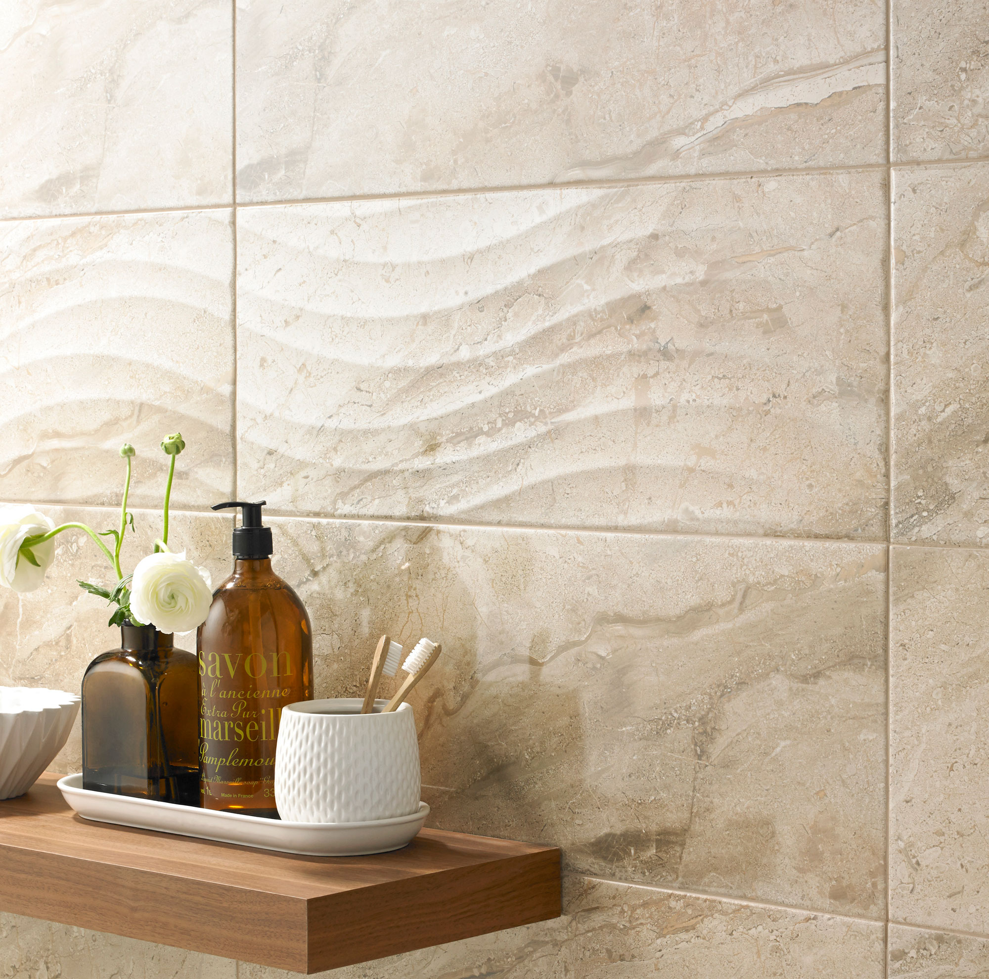 Cream wave design tiled bathroom with natural wood shelves